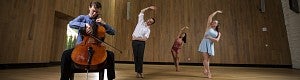 musician and dancers practicing on stage
