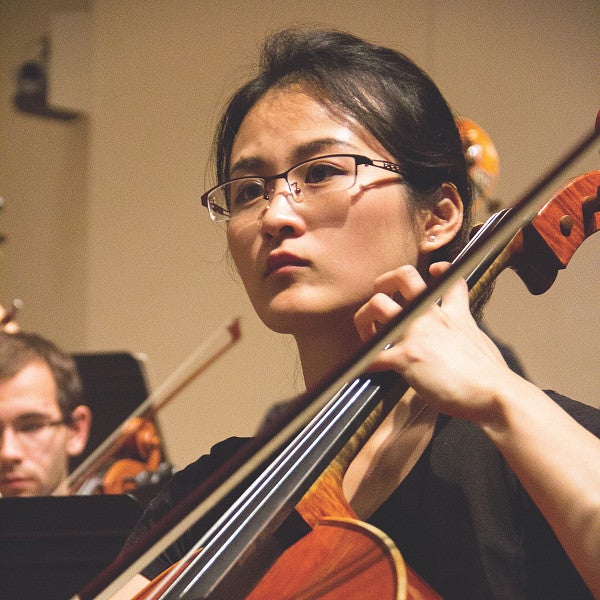 Student playing instrument in group