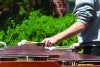 Student playing percussion instrument outdoors